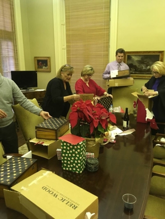 Kinnard Clayton & Beveridge employees open their presents.